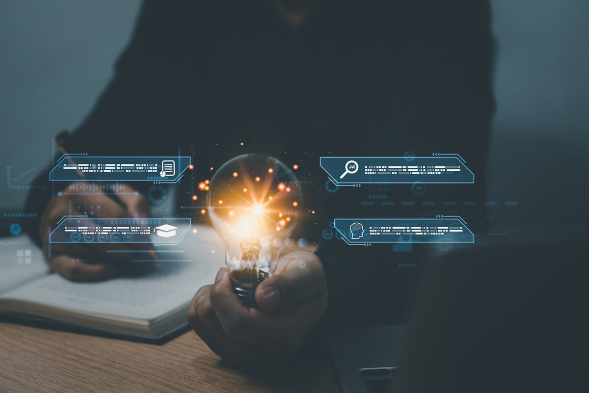 A person developing an innovation idea with a glowing light bulb and digital research symbols.